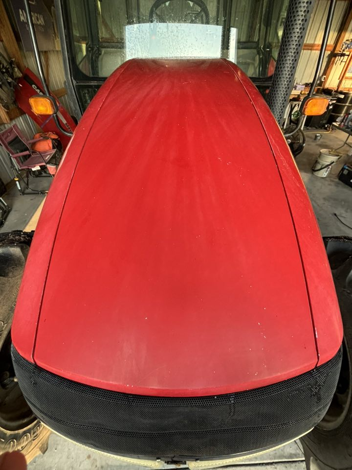 Polished red tractor hood showing mirror finish
