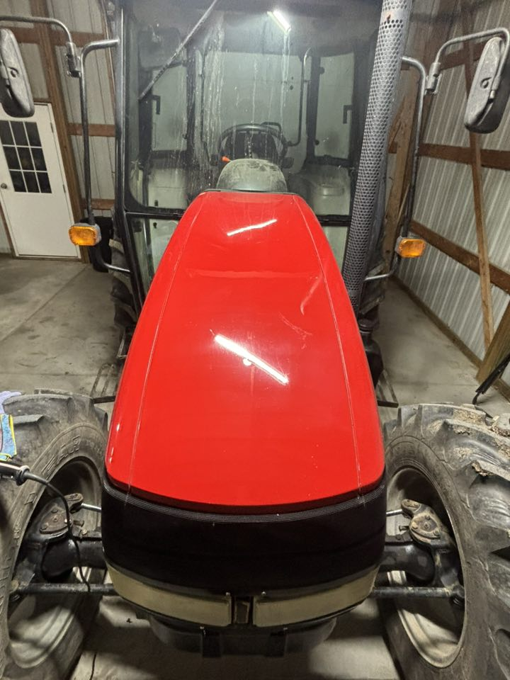 Polished red tractor showing professional detailing results